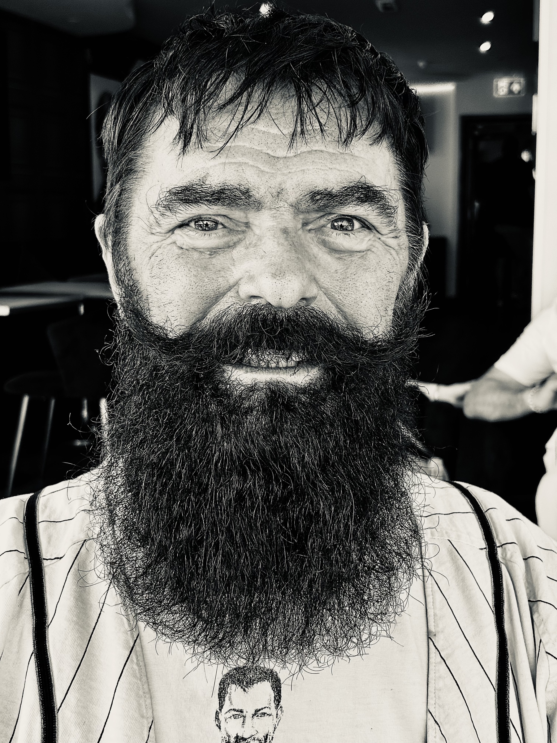 Black and white close portrait of Greg W. with a full beard.